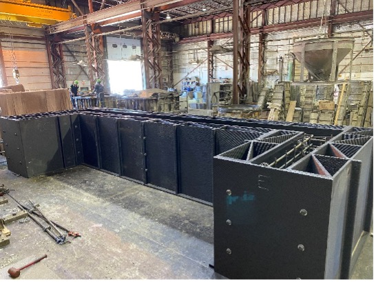 Large-scale railroad bridge ballast retainer formwork at American Concrete Ind. plant in Veazie, Maine. 