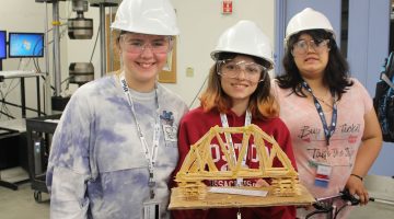 sixth graders posing with homemade bridge at ascc lab