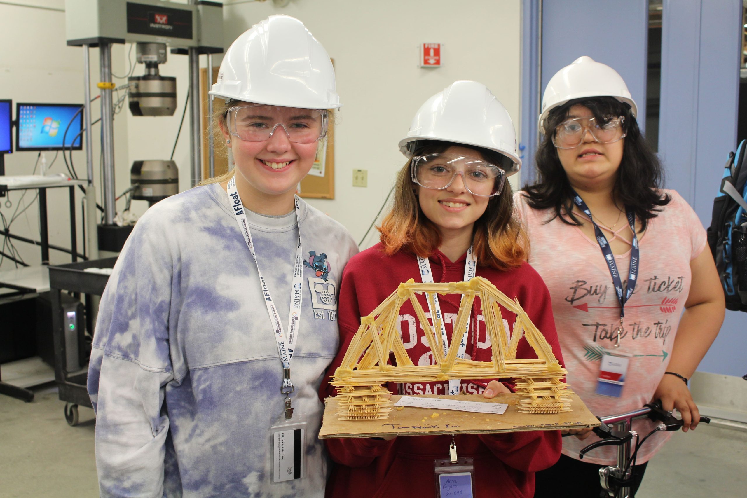 sixth graders posing with homemade bridge at ascc lab