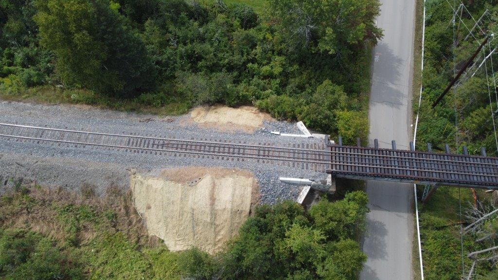 An arial view of the completed railroad bridge with ballast retainer now covered in gravel and railroad track